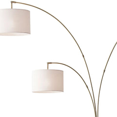 74" Brass Three Light Arc Floor Lamp With Off White Fabric Drum Shade