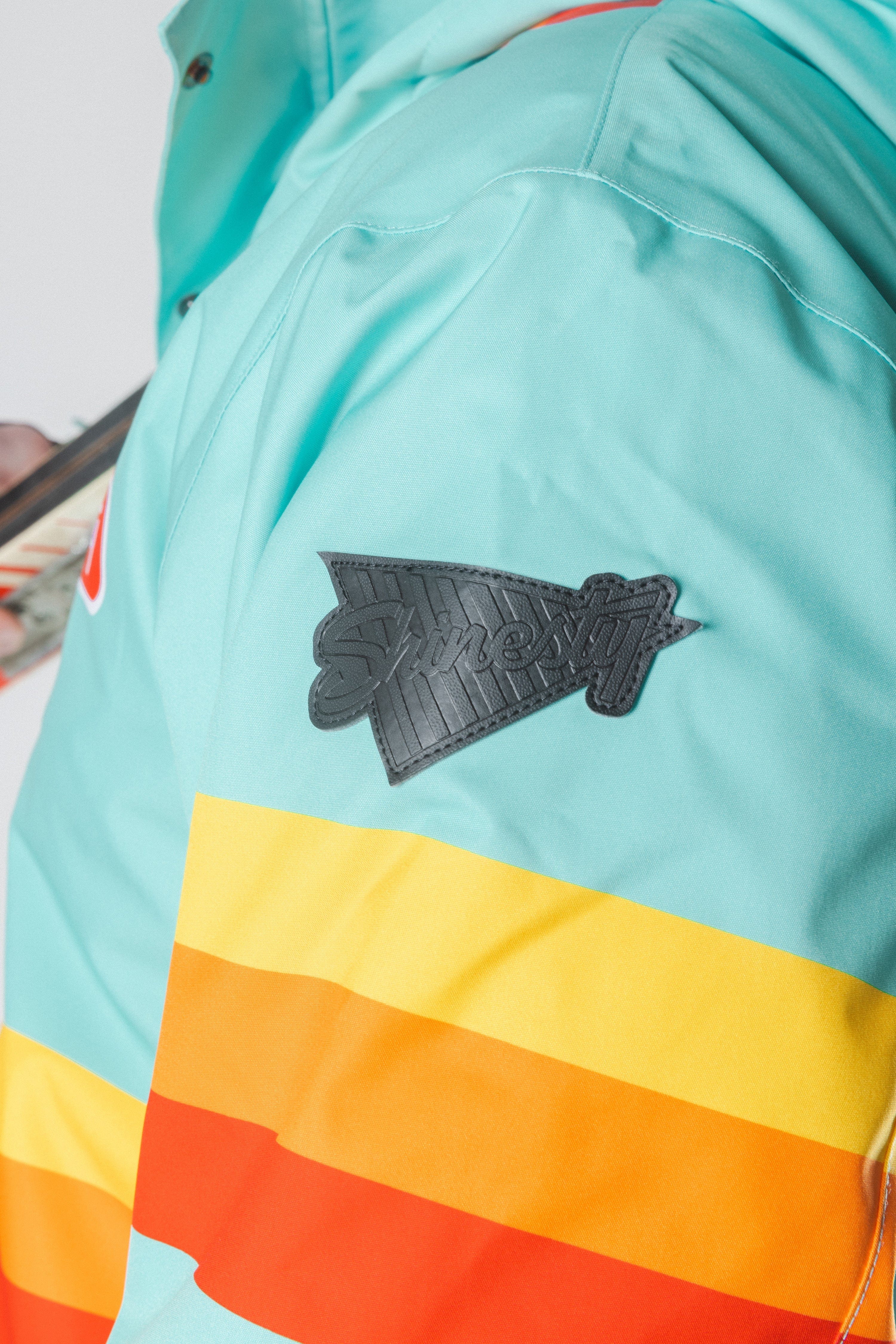 The Midday Aprés | Teal and Orange Retro Stripe One Piece Ski Suit - Shinesty