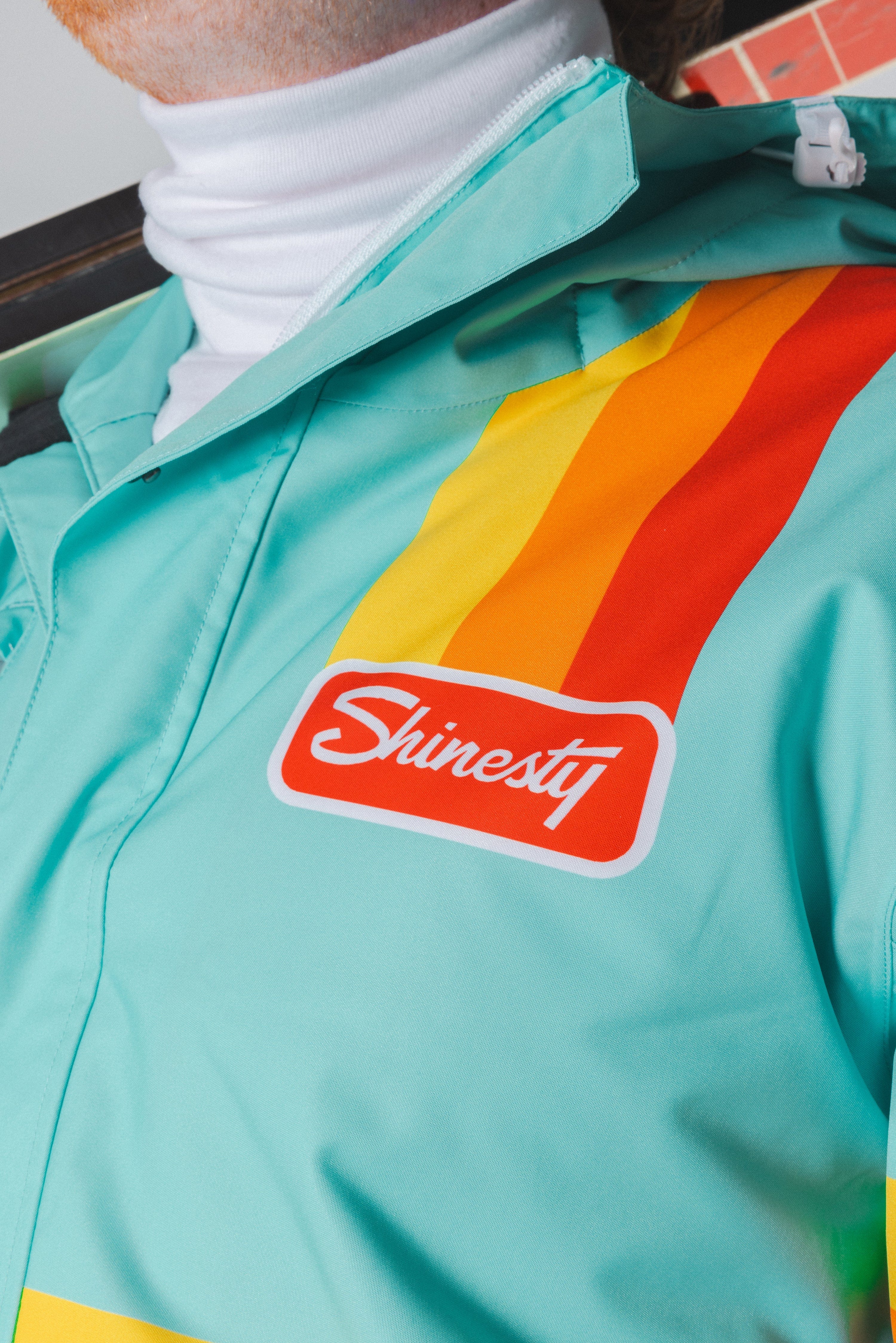 The Midday Aprés | Teal and Orange Retro Stripe One Piece Ski Suit - Shinesty