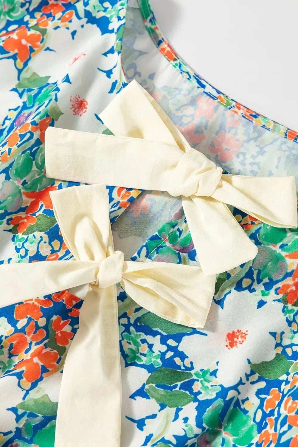 Floral Print Bow Applique Slit Sleeveless Peplum Blouse - Trendsi - Flyclothing LLC