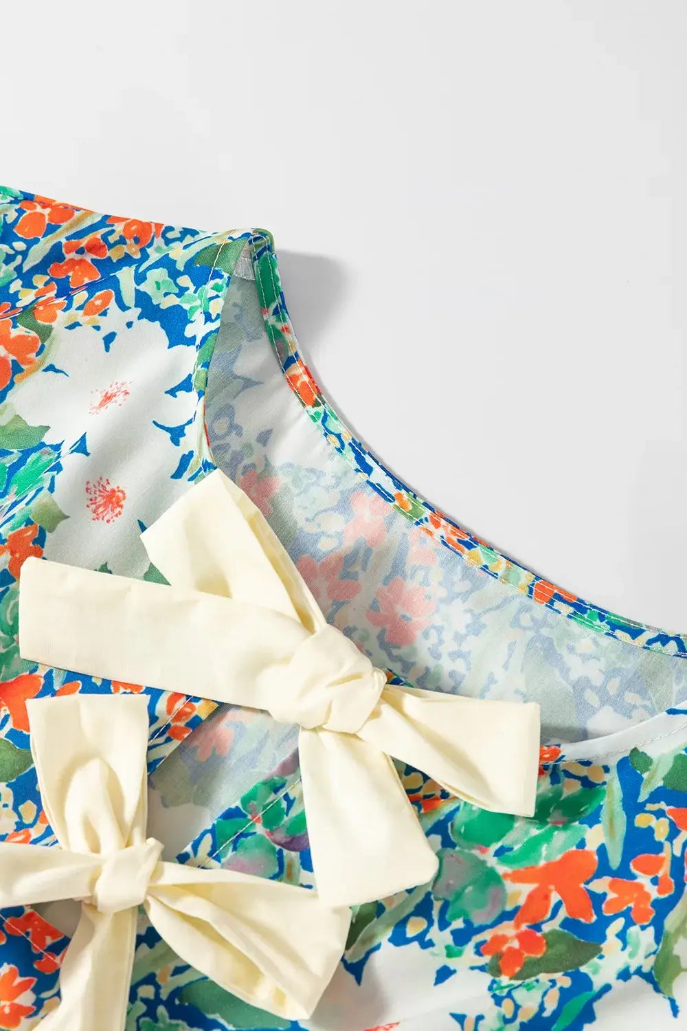 Floral Print Bow Applique Slit Sleeveless Peplum Blouse - Trendsi - Flyclothing LLC